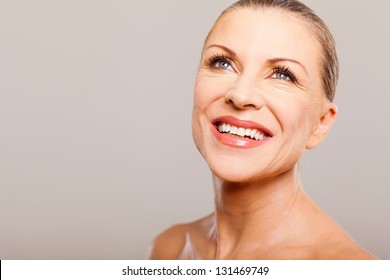 happy attractive middle aged woman looking up and smiling