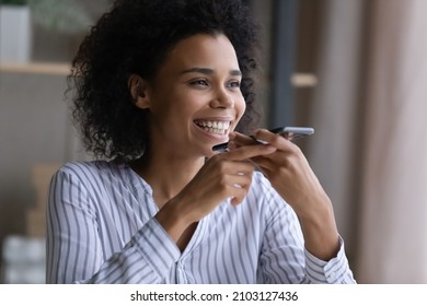 Happy Attractive Millennial African American Multiracial Woman Recording Audio Message On Cellphone, Holding Pleasant Loudspeaker Distant Conversation, Checking Voicemail Or Using Ai Assistant App.