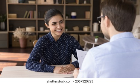 Happy Attractive Millennial Indian Female Job Seeker Holding Interview With Male Leader, Making Good First Impression At Meeting, Discussing Working Offer In Modern Office, Employment Concept.