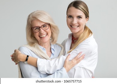 Happy Attractive Senior Older Aged Mother And Young Adult Daughter Smiling Laughing Looking At Camera, Two Beautiful Women Having Fun Embracing Head Shot Portrait, Cheerful Family Hugging Concept