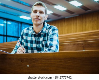 Happy Attractive Smiling Student Alone In Big Lecture Hall