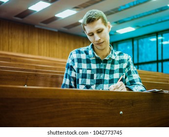 Happy Attractive Smiling Student Alone In Big Lecture Hall