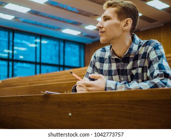 Happy Attractive Smiling Student Alone In Big Lecture Hall