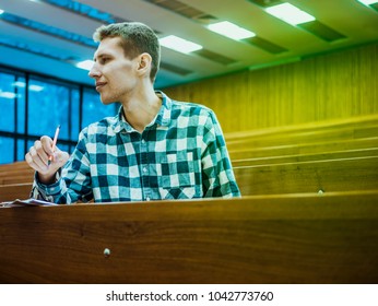 Happy Attractive Smiling Student Alone In Big Lecture Hall