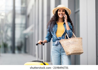 Happy Attractive Young Brunette Woman In Casual Tourist Having Phone Conversation While Walking Outside Airport, Arrived For Summer Vacation, Having Phone Conversation With Friend, Copy Space