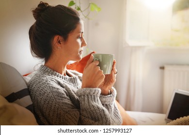 Happy attractive young woman on laptop in bed - Powered by Shutterstock