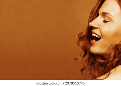 Happy Atumn Sales concept. Profile portrait of beautiful laughing fashion model with long red curly hair posing on wooden background. Natural make-up, clean skin. Close up. Copy-space. Studio shot