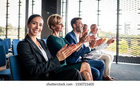 Happy Audience Applauding Speaker At Business Conference