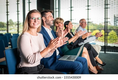 Happy Audience Applauding Speaker At Business Conference