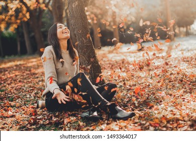 Happy Autumn. Beautiful woman having fun in fall park.