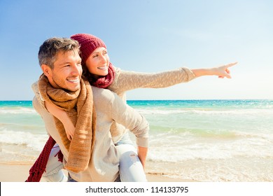 happy autumn fall couple showing with outstretched arms - Powered by Shutterstock