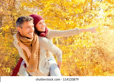 Happy Autumn Fall Couple Showing With Outstretched Arms