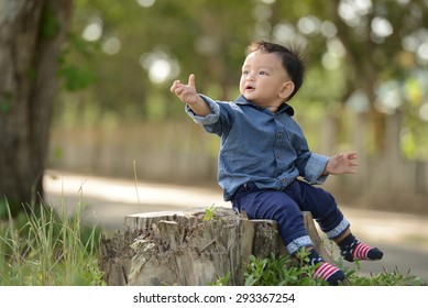 Happy Baby 1 Year Old Sitting And Playing In The Park