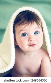 Happy Baby With Blanket Over Head.