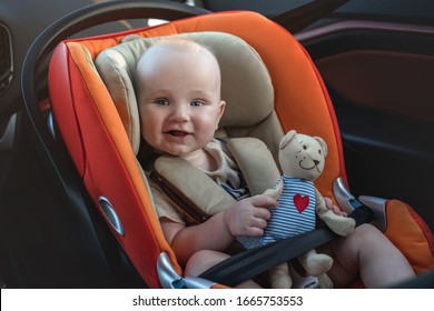 Happy Baby Boy In The Car Seat.