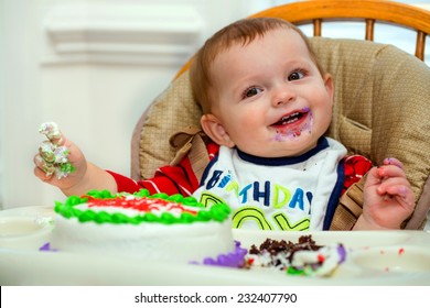 Happy Baby Boy Eating Cake For His First Birthday Party