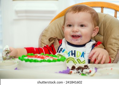 Happy Baby Boy Eating Cake For His First Birthday Party 