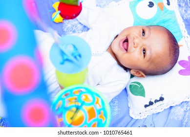 Happy Baby Boy Playing With Baby Play Gym