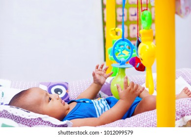 
Happy Baby Boy Playing With Baby Play Gym