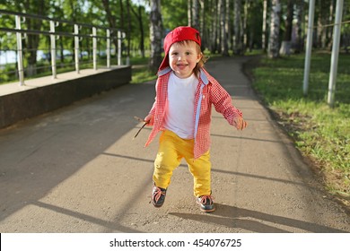 Happy Baby Boy Running Outdoors In Summer