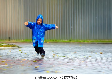 Happy Baby Boy Running The Street, Rainy Weather