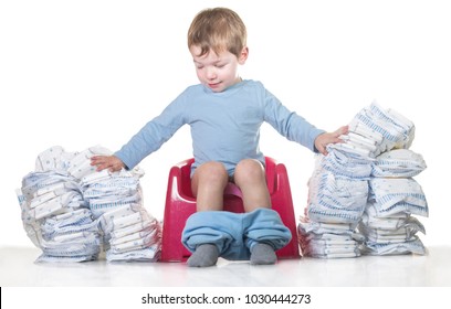 Happy Baby Boy Sitting On Chamber Pot Tearing Down Diaper Piles. Potty Training Concept