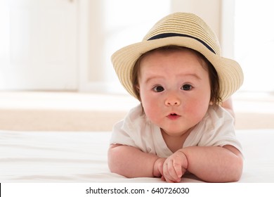 Happy Baby Boy With A Straw Hat