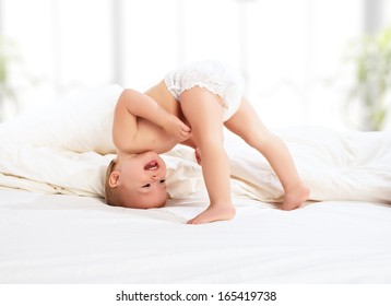 happy baby child play fun in bed