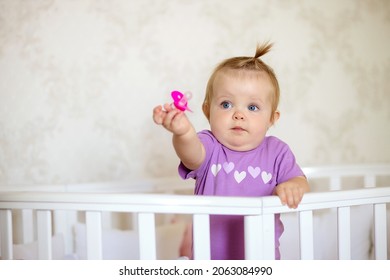 happy baby in crib with pacifier