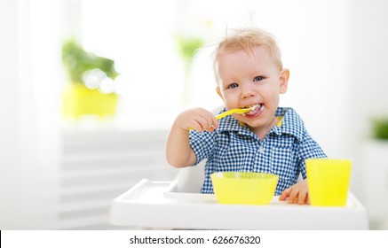  Happy Baby Eating Himself With A Spoon
