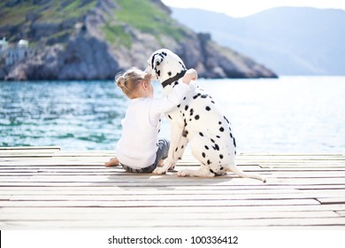 Happy Baby Girl With Her Dog On Berth In Summer