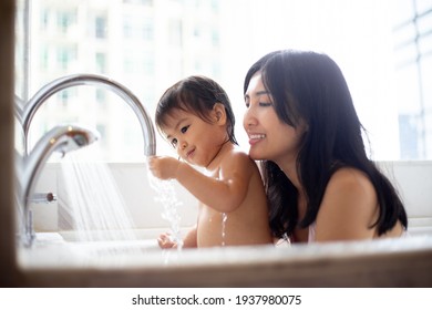 Happy Baby Girl Taking A Bath With Her Mom