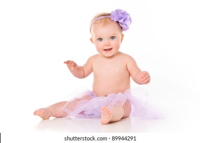 Happy Baby Girl Wearing A Tutu And Bow In Her Hair