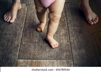 baby learning to walk on hardwood floors