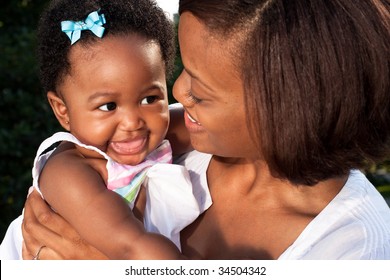 a happy baby looks at her mother