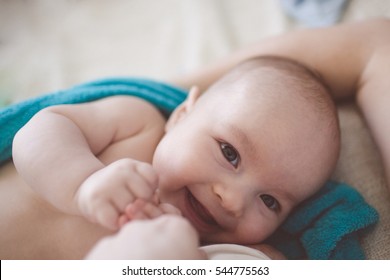 Happy Baby Lying Next To The Mother, Breastfeeding