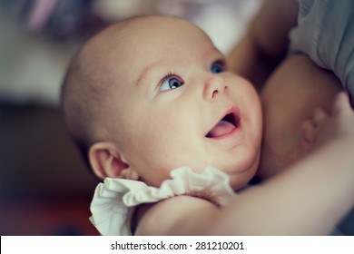 happy baby in the mother's breast