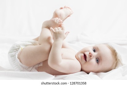 Happy Baby playing with his feet