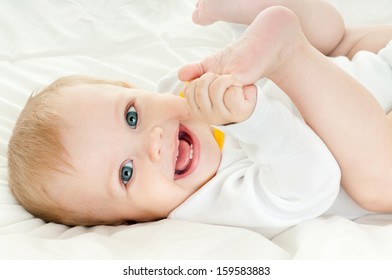 Happy Baby Playing With His Feet