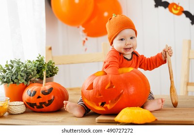 Happy  Baby With A Pumpkin For Halloween Home