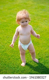 Happy Baby Running In A Spring Field And Wearing A Diaper. First Step.