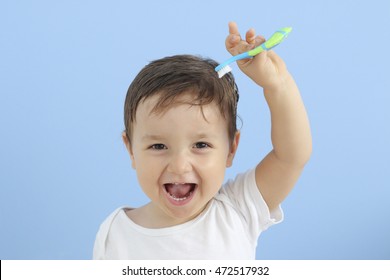 baby with toothbrush