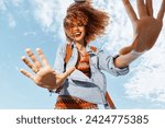 Happy Backpacking Adventure on the Beach: Smiling Woman Dancing With Open Mouth Showing Freedom and Joy in Nature