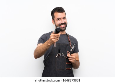 Happy Barber man in an apron over isolated white background - Powered by Shutterstock