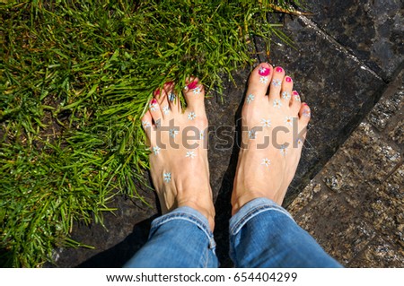 Happy barefoot legs in city, top view