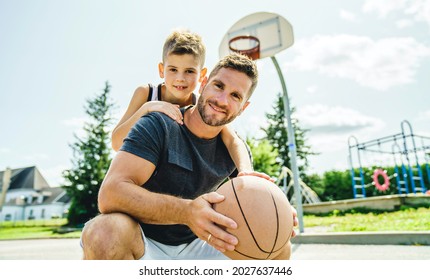 A Happy basketball family portrait play this sport on summer season. The father play with boy - Powered by Shutterstock