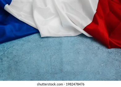Happy Bastille Day. 14th July. Flag of France on a blue background. Celebrating a public holiday. Independence Day. Greeting card or banner. Top view. Layout