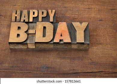 happy b-day (birthday) - text in vintage letterpress wood type on a grunge wooden background