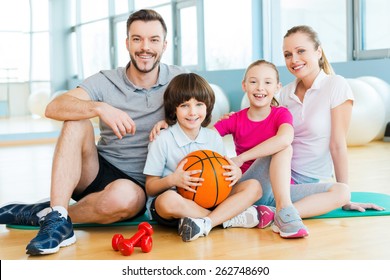 Happy To Be A Family. Happy Sporty Family Bonding To Each Other While Sitting On Exercise Mat Together  