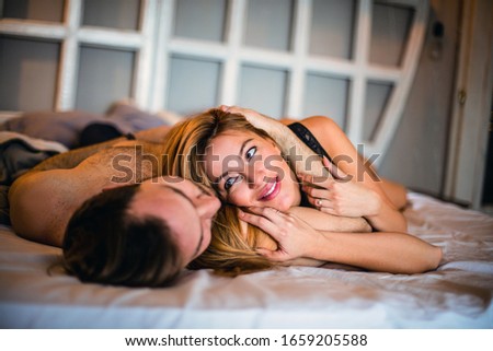 Similar – Beautiful woman looking to man lying on bed